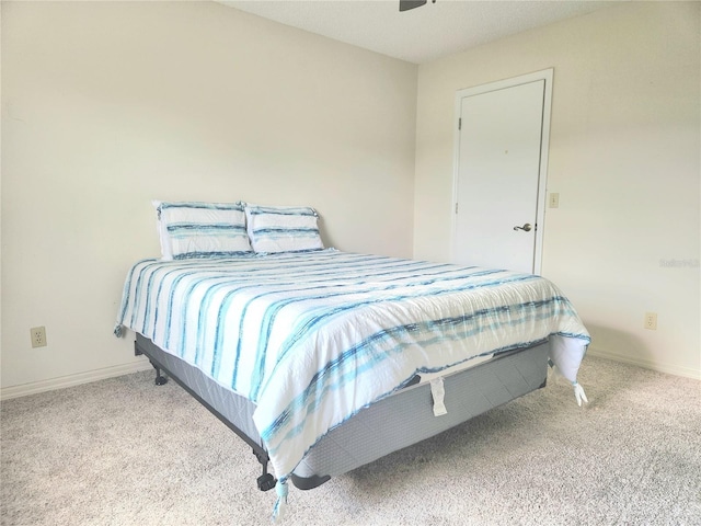 bedroom featuring carpet floors and baseboards