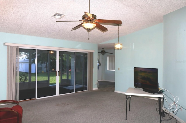 living room featuring lofted ceiling, a textured ceiling, ceiling fan, carpet floors, and visible vents