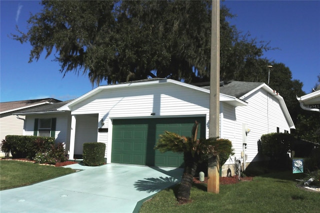 view of front of home with concrete driveway, an attached garage, and a front yard