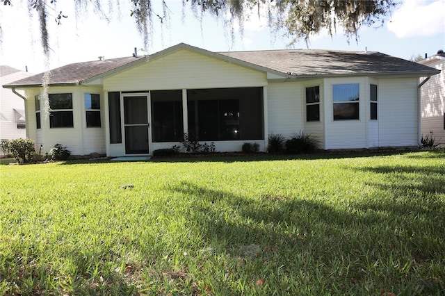 view of front facade with a sunroom and a front yard