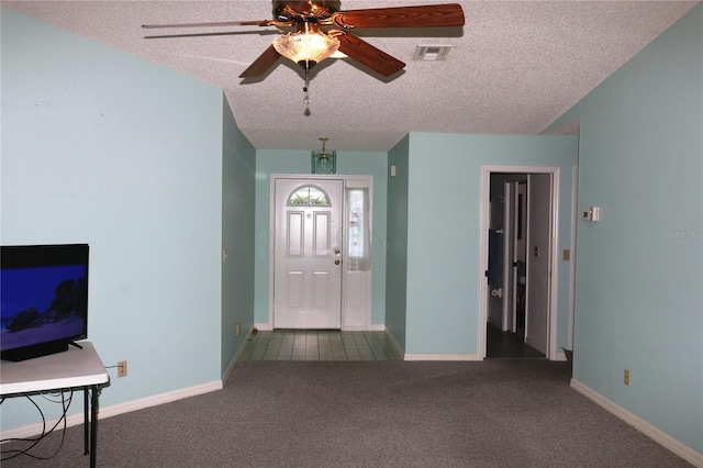 entryway featuring baseboards, visible vents, ceiling fan, a textured ceiling, and carpet flooring