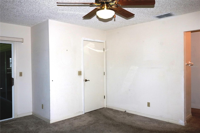 unfurnished bedroom featuring baseboards, carpet, visible vents, and a textured ceiling