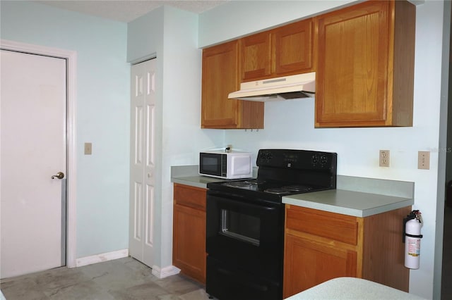 kitchen with brown cabinetry, white microwave, black electric range oven, light countertops, and under cabinet range hood