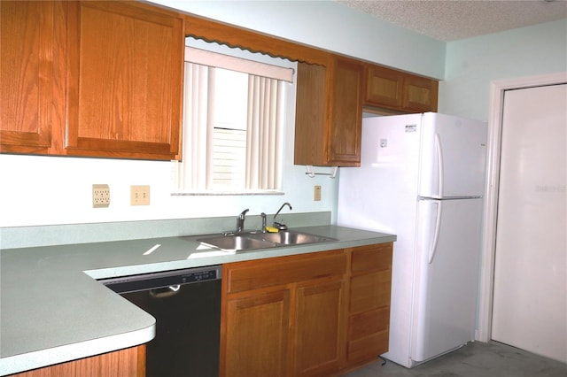 kitchen featuring a textured ceiling, dishwashing machine, a sink, and brown cabinets