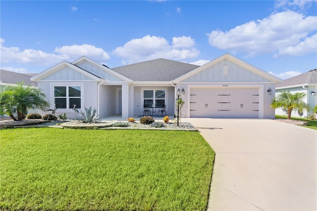 view of front of house featuring a garage and a front lawn