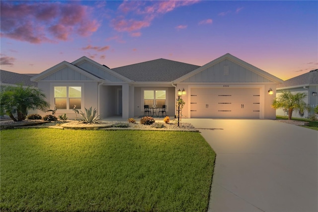 view of front of house with a yard and a garage