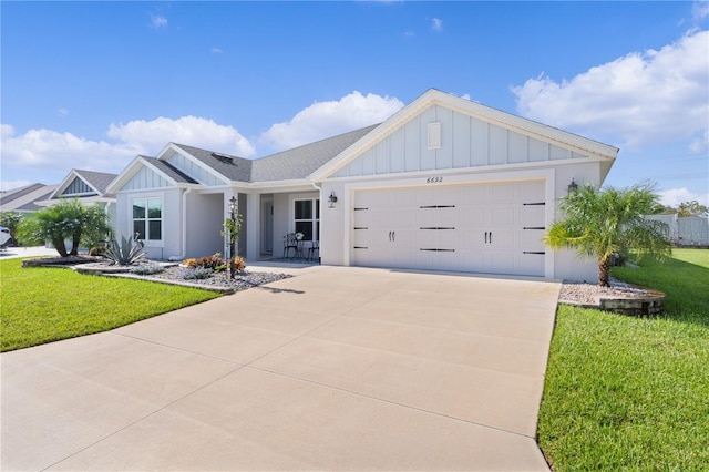 view of front of home with a front lawn and a garage