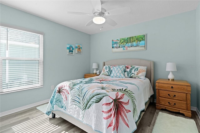 bedroom featuring ceiling fan and hardwood / wood-style flooring