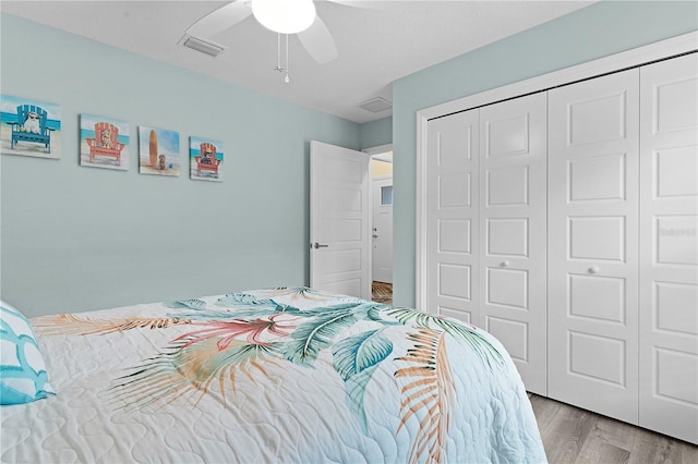 bedroom with ceiling fan, a closet, and light hardwood / wood-style flooring