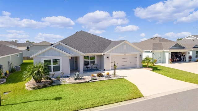 view of front of house with a garage, central air condition unit, and a front yard