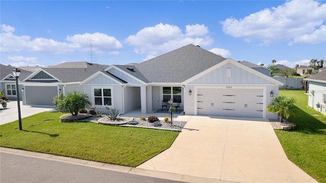 view of front of property with a garage and a front lawn