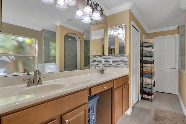 bathroom featuring vanity, a shower, crown molding, tile patterned flooring, and decorative backsplash