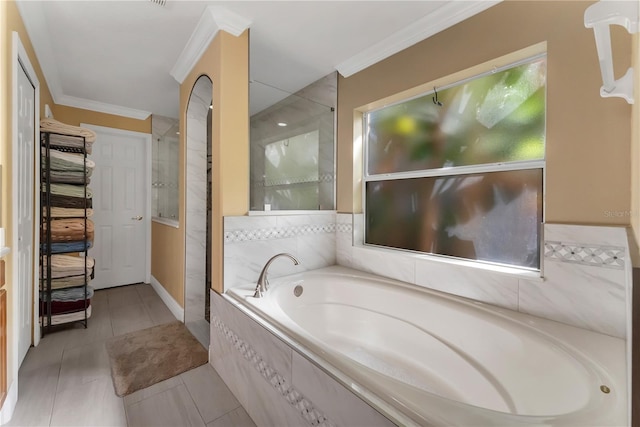 bathroom featuring separate shower and tub, tile patterned flooring, and ornamental molding