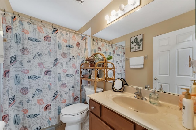 bathroom featuring vanity, toilet, and a shower with shower curtain