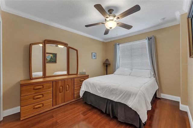 bedroom with ornamental molding, dark hardwood / wood-style floors, and ceiling fan