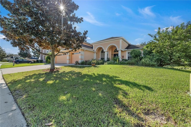 view of front of house featuring a garage and a front lawn