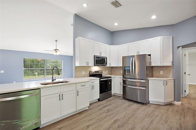 kitchen featuring light hardwood / wood-style floors, white cabinetry, sink, and stainless steel appliances