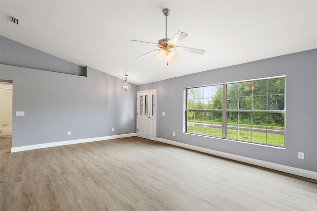 unfurnished living room featuring ceiling fan, hardwood / wood-style floors, and vaulted ceiling