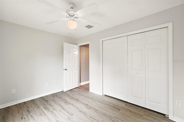 unfurnished bedroom with ceiling fan, a closet, and light hardwood / wood-style floors