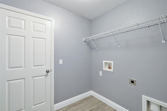 clothes washing area with washer hookup, hookup for an electric dryer, and hardwood / wood-style flooring