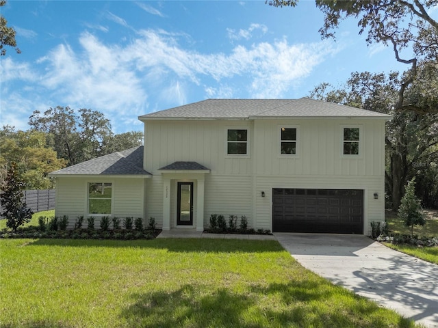 view of front of property with a front lawn and a garage