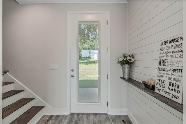 doorway to outside with hardwood / wood-style flooring and ornamental molding