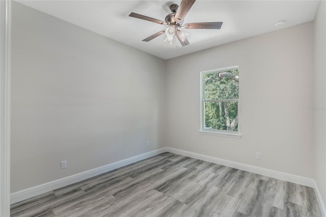 empty room featuring light hardwood / wood-style flooring and ceiling fan