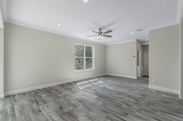 spare room featuring crown molding, hardwood / wood-style floors, and ceiling fan