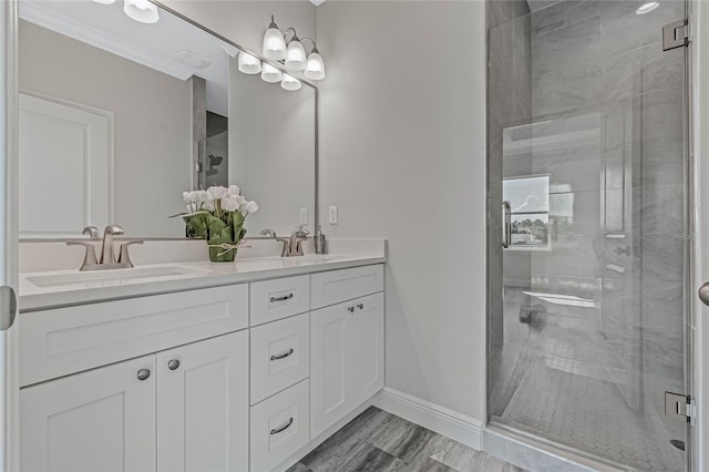 bathroom featuring a shower with door and vanity