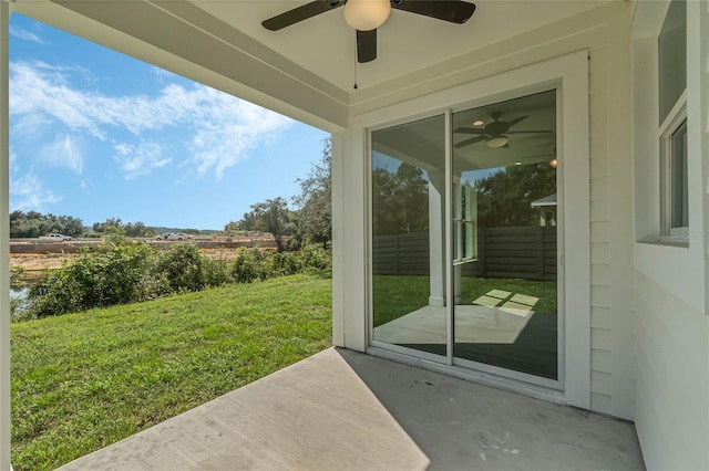 exterior space featuring ceiling fan and concrete flooring