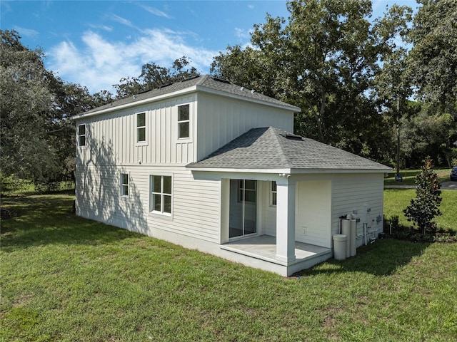 rear view of property with a patio area and a lawn