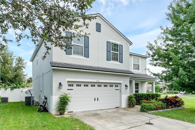 view of front facade featuring a front yard and a garage