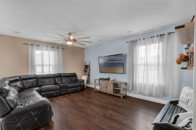 living room with ceiling fan, dark hardwood / wood-style flooring, and a healthy amount of sunlight