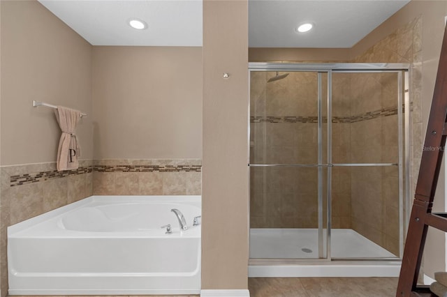 bathroom with shower with separate bathtub and tile patterned floors