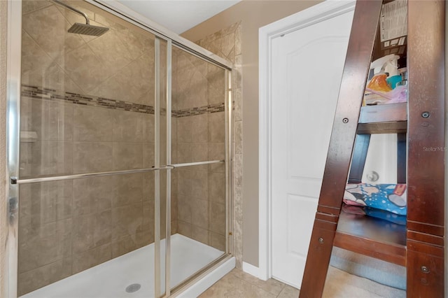 bathroom featuring a shower with door and tile patterned floors