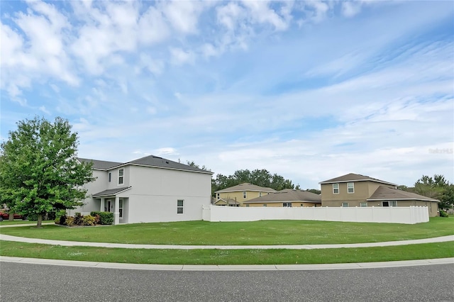 view of side of property with a yard