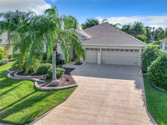 view of front of property featuring a front lawn and a garage