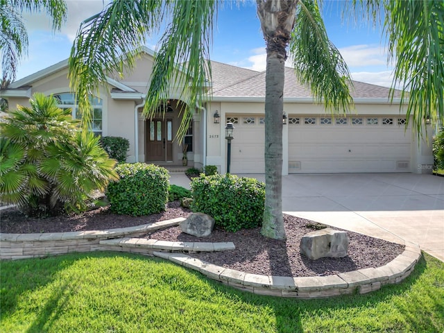 ranch-style home featuring a garage and a front lawn