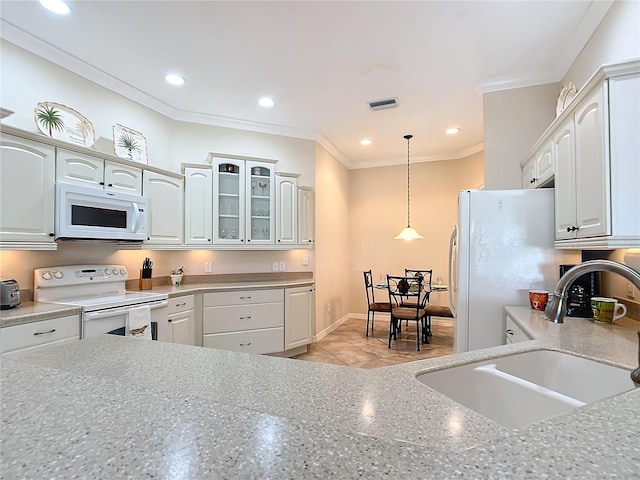 kitchen featuring white cabinetry, sink, white appliances, and decorative light fixtures