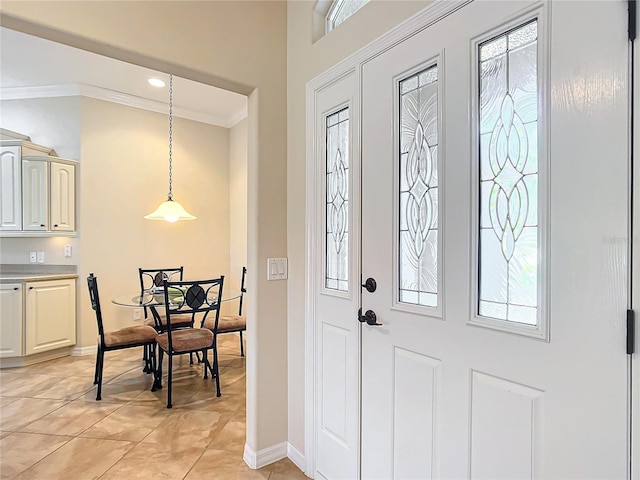 tiled foyer featuring ornamental molding