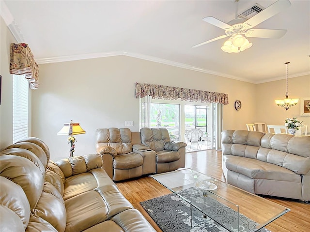 living room with crown molding, ceiling fan with notable chandelier, light hardwood / wood-style floors, and vaulted ceiling