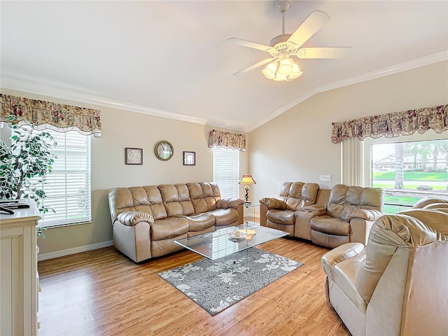 living room featuring crown molding, plenty of natural light, and lofted ceiling