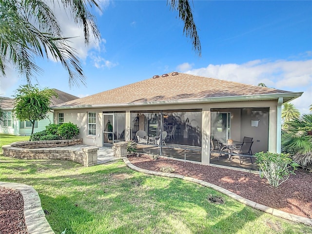 back of house with a sunroom, a yard, and a patio area