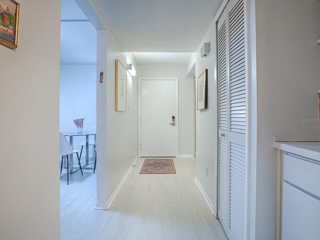 hallway with a textured ceiling