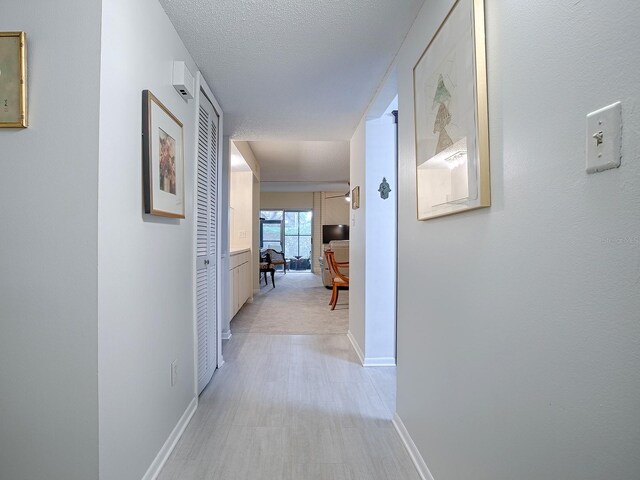 hallway featuring a textured ceiling