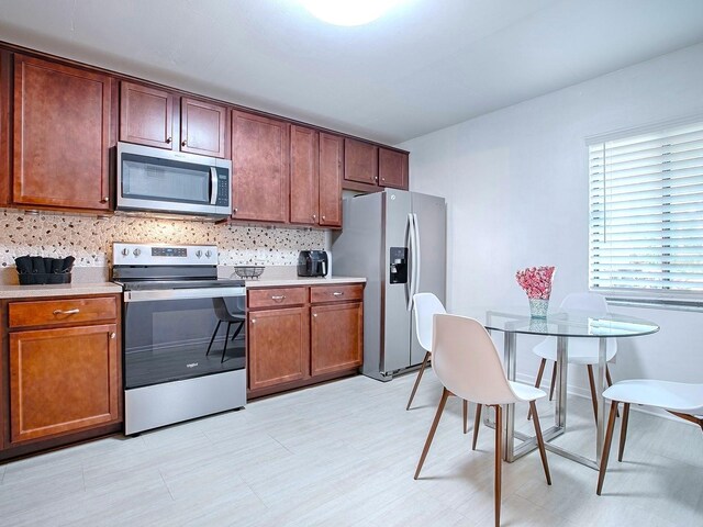 kitchen featuring appliances with stainless steel finishes and tasteful backsplash