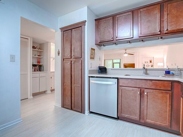 kitchen with dishwasher, sink, built in shelves, and ceiling fan