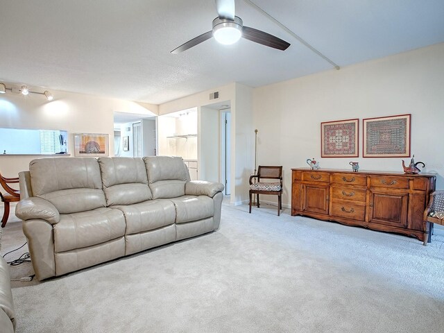 living room featuring light colored carpet and ceiling fan