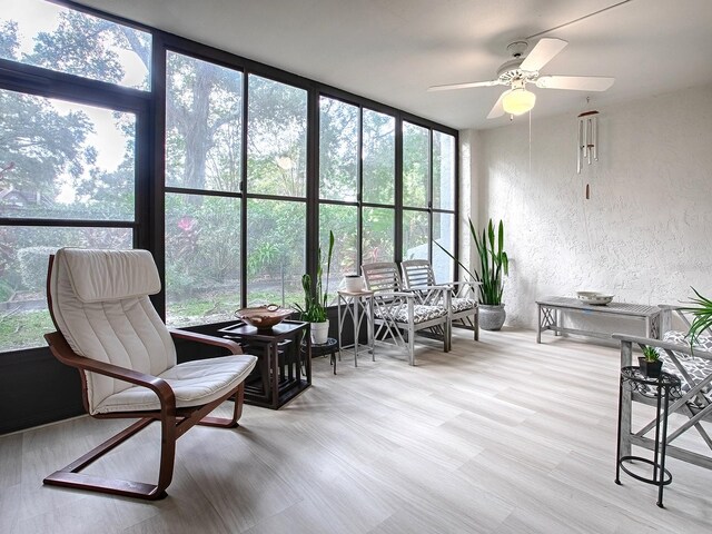 sunroom with ceiling fan and plenty of natural light