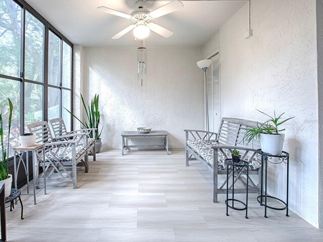 sunroom / solarium with ceiling fan